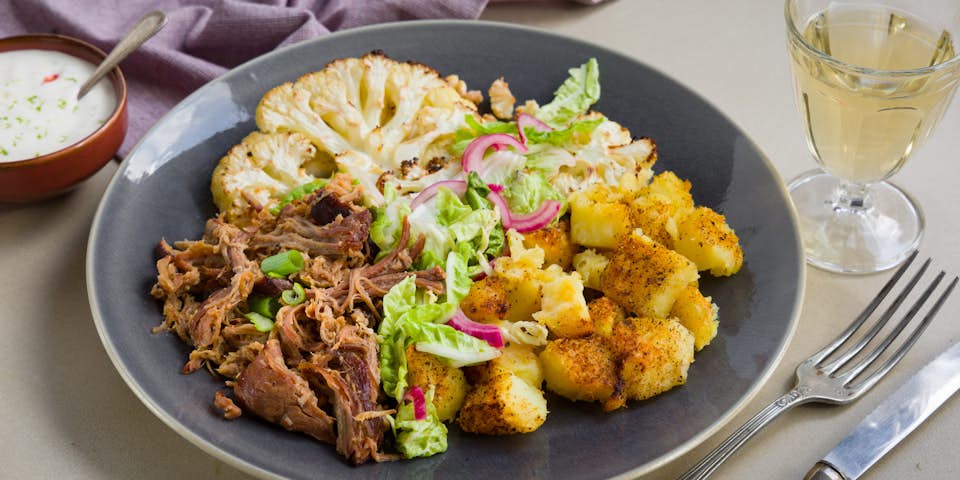 Pulled pork met oranje bloemkool steaks geroosterde aardappeltjes en een frisse yoghurtsaus | Maaltijdbox recepten